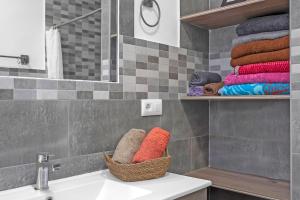 a bathroom with a sink and a basket of towels at Loft Rural in El Soto +21 photos