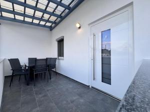 a room with a table and chairs and a sliding door at Dreams Lodge in Koetz  +4 photos
