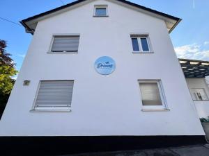 a white building with a blue sign on it at Dreams Lodge in Koetz 