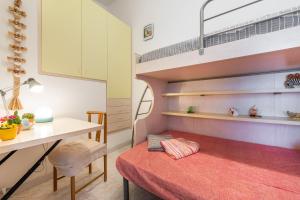 a room with a bed and a desk and a loft bed at Villetta Lelu' in Villasimius