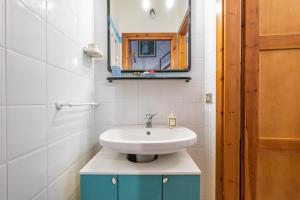a bathroom with a sink and a mirror at Villetta Lelu' in Villasimius