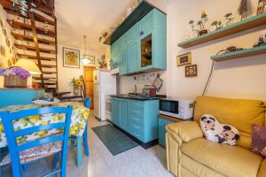 a kitchen with blue cabinets and a couch at Villetta Lelu' in Villasimius +17 photos