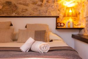 a bedroom with a bed with a towel on it at Es Forn in Petra +26 photos