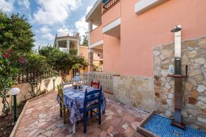 a table and chairs on a patio in front of a building at Villetta Lelu' in Villasimius