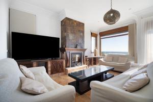a living room with a tv and a fireplace at Carolina Beach House in Chiclana de la Frontera