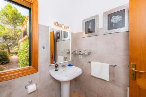 a bathroom with a sink and a mirror at Garballo in Betlem +22 photos