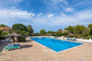 a large swimming pool with chairs and umbrellas at Garballo in Betlem