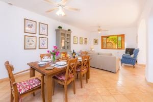 a dining room with a table and chairs and a couch at Garballo in Betlem