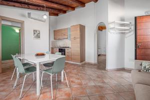 a kitchen and dining room with a white table and chairs at Residence Orizzonti 33 in Golfo Aranci