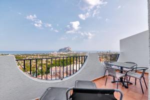 a balcony with a table and chairs and the ocean at Clementina Imperial Park in Calpe