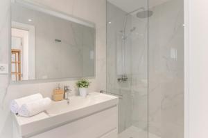 a white bathroom with a sink and a shower at Casa Ancla in Tías +13 photos