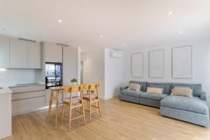 a kitchen and a living room with a table and a couch at Casa Ancla in Tías