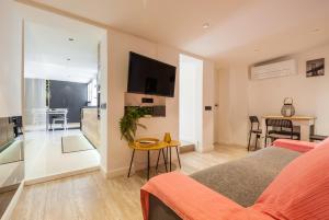 a living room with a bed and a table at Dulce y acogedor in Vilanova i la Geltrú +7 photos