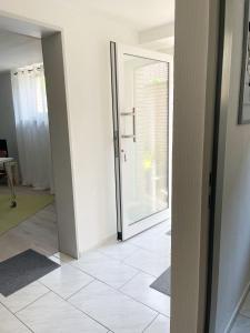 a hallway with a door and a tile floor at Ruhiges Apartment Münster Baumberge in Nottuln +31 photos
