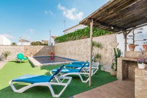 a patio with lounge chairs and a pool at Chalet Aragon Muñoz in Conil de la Frontera