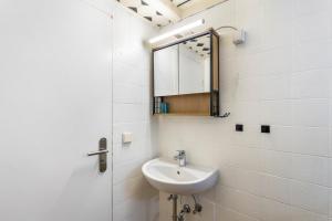 a bathroom with a sink and a mirror at Ferienwohnung Am Osttor in Warendorf +14 photos