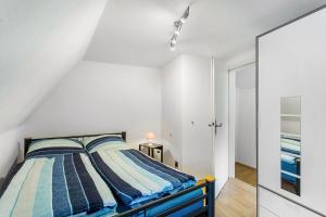 a bedroom with a bed with striped pillows at Ferienwohnung Am Osttor in Warendorf