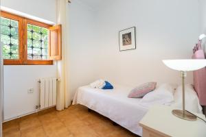 a bedroom with a bed and a window at Villa Can Joan den Coves in Santa Gertrudis de Fruitera +22 photos