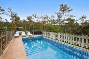 a swimming pool with chairs and a gazebo at Cal Panxeta in Balsareny