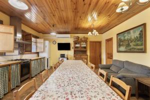 a living room with a long table and a couch at Cal Panxeta in Balsareny