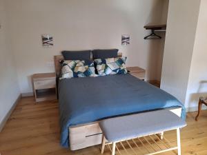 a bedroom with a bed with a blue comforter at Maison Maurer in Aschbach
