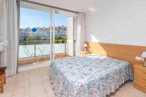 a bedroom with a bed and a large window at Fantàstic s'agaró in S'agaro +21 photos