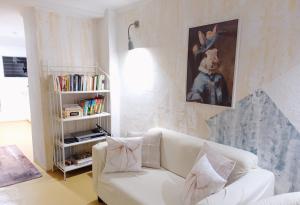a living room with a white couch and a book shelf at Ca Les Nines 2 in Pinell de Bray