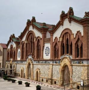 a large brick building with a clock on it at Ca Les Nines 2 in Pinell de Bray