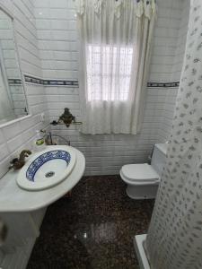 a bathroom with a sink and a toilet at Finca Campo Viejo in Isla Cristina +20 photos