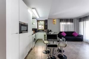 a kitchen and living room with a couch and a table at Apartamento Costa Brava in Blanes