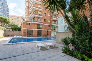 a building with a swimming pool in front of a building at Apartamento Costa Brava in Blanes