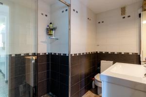 a bathroom with a shower and a toilet and a sink at Apartamento Costa Brava in Blanes +19 photos