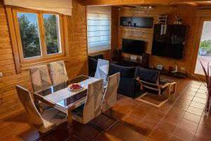 a living room with a table and a couch at Casa de Madera en Calafell in Calafell