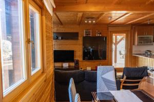 a living room with a couch and a table at Casa de Madera en Calafell in Calafell