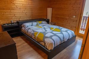 a bedroom with a bed and a wooden wall at Casa de Madera en Calafell in Calafell +35 photos