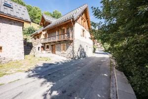 an empty road in front of a house at Chalet La Grange des Flocons in Valloire