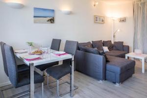a living room with a couch and a table at Ferienpark N3 -3 in Heiligenhafen