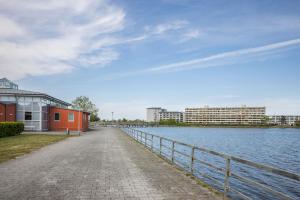 a road next to a body of water with buildings at Ferienpark N3 -3 in Heiligenhafen