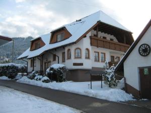 a large house with snow on the roof at Faißbauernhof in Winden im Elztal