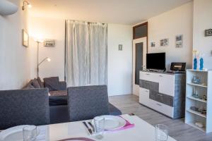 a living room with a dining table and a living room at Ferienpark N3 -3 in Heiligenhafen