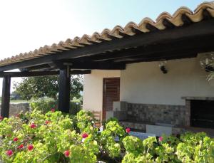 a pergola over a patio with flowers in a garden at Isola Di Favignana in Favignana
