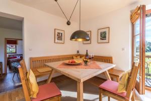 a dining room with a table and chairs at Alpen Chalet Alte Talstation in Lenggries +17 photos