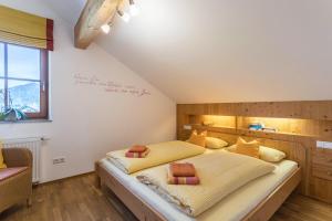 a bedroom with a large bed and a window at Alpen Chalet Alte Talstation in Lenggries