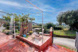 a patio with a table and chairs and a fence at Grenta Country House in Corfu +17 photos