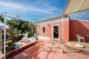 a small house with a patio and a yard at Grenta Country House in Corfu