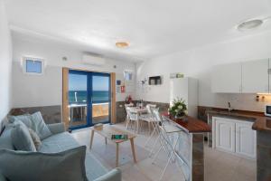 a kitchen and living room with a couch and a table at Apartamentos Playa Azul - 5 in Vallehermoso +19 photos