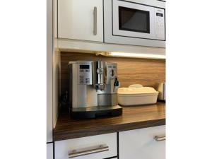 a coffee maker in a kitchen with a microwave at Ferienwohnung Max 2 in Garmisch-Partenkirchen +27 photos