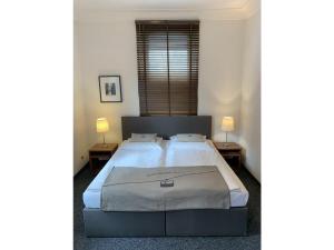 a bedroom with a bed with two lamps on two tables at Ferienwohnung Max 2 in Garmisch-Partenkirchen