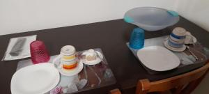 a table with colorful plates and a bowl on it at B e B Beglia Alguer in Alghero +20 photos