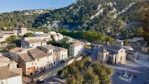 an aerial view of a town with a mountain at Canto Cigalo Rdc 1 in Robion en Luberon